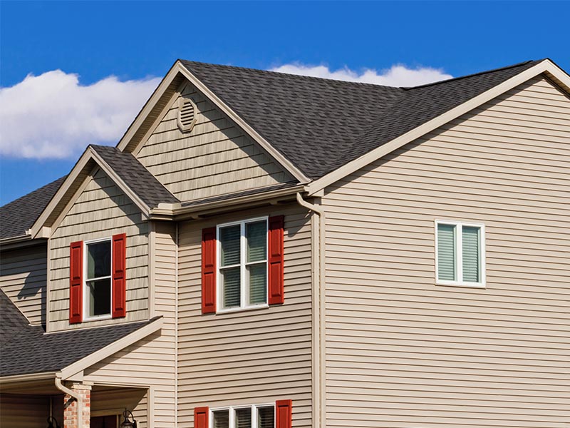 Modern residential home with new beige siding.